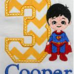 The super hero here is totally embroidered.  It is NOT an applique.  You can add any applique number you would like.  Add $5.00 for the number of stitches involved in this design.  Includes name.